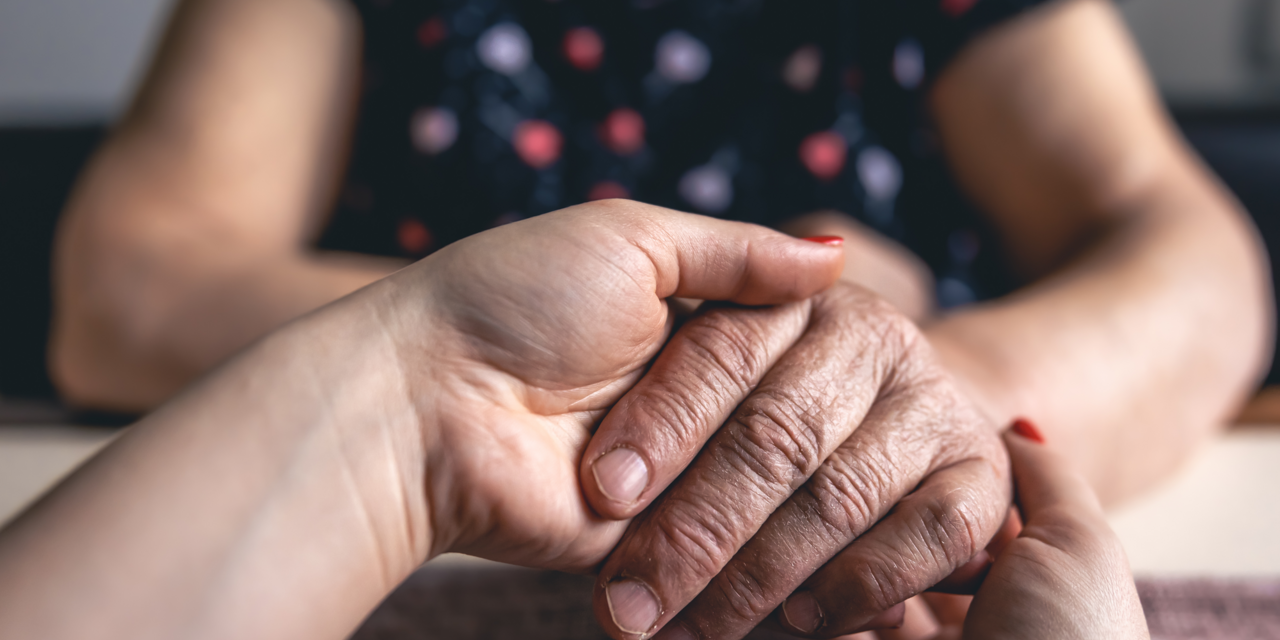 Zwei Hände, die eine andere Hand halten