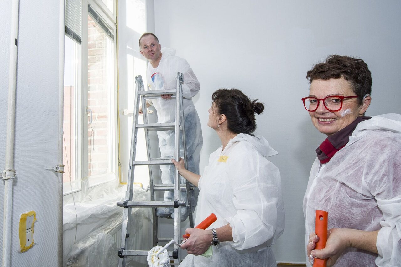 Drei Personen in Arbeitsmontur