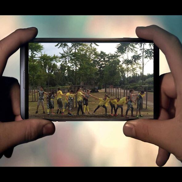 Smartphonedisplay mit tanzenden Jugendlichen
