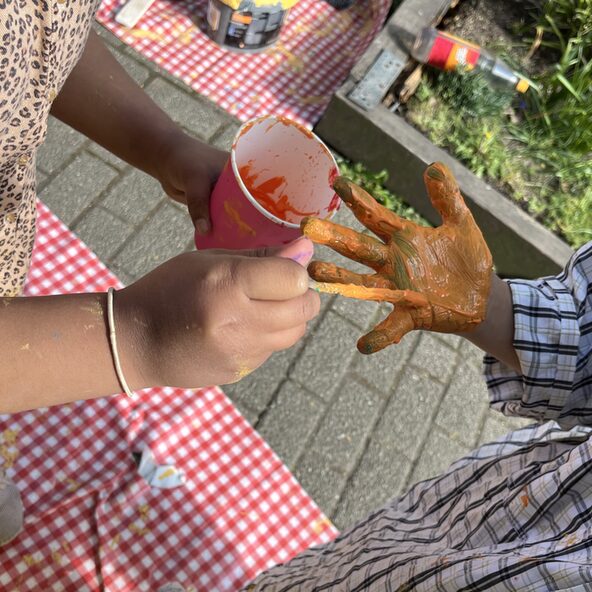 Kinder bemalen Hände mit Farbe