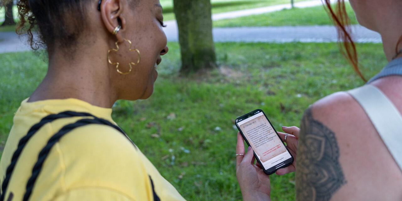 Zwei Frauen schauen auf ein Smartphone.
